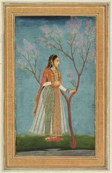 Lady standing by a tree in blossom, from the Small Clive Album